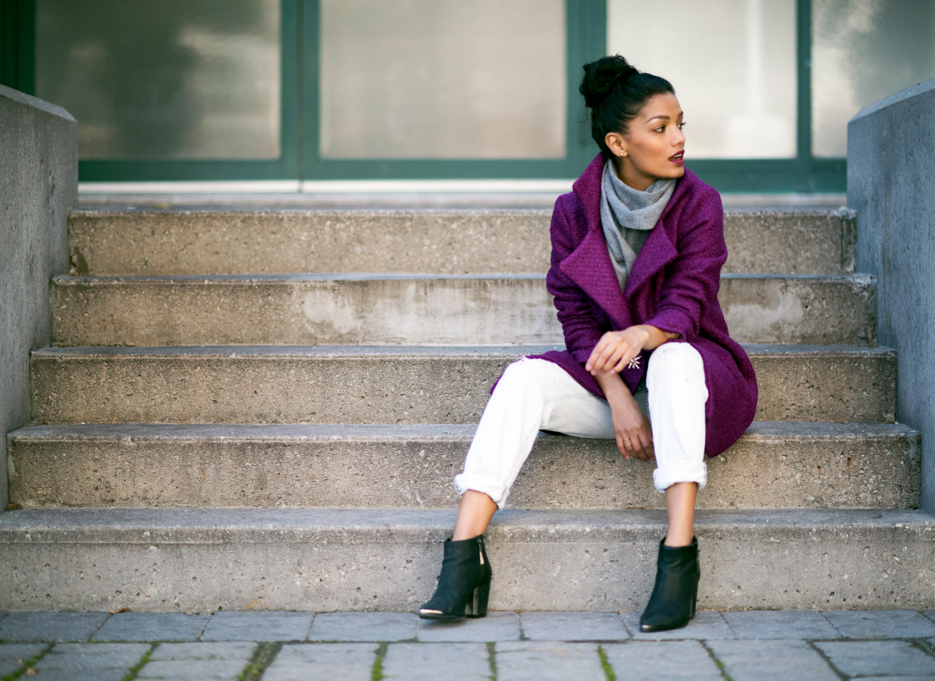 Sweet Shard sitting on concrete steps wearing her purple DIY oversized winter coat